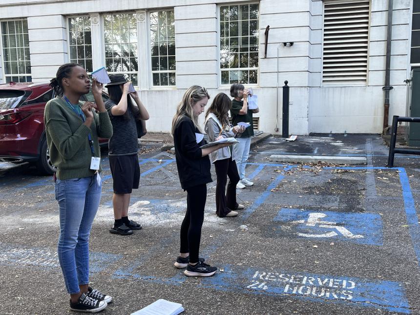 students work in groups outdoors  on medieval navigation instruments