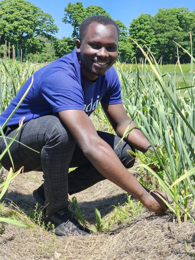 Samuel Siaw kneeling outside.