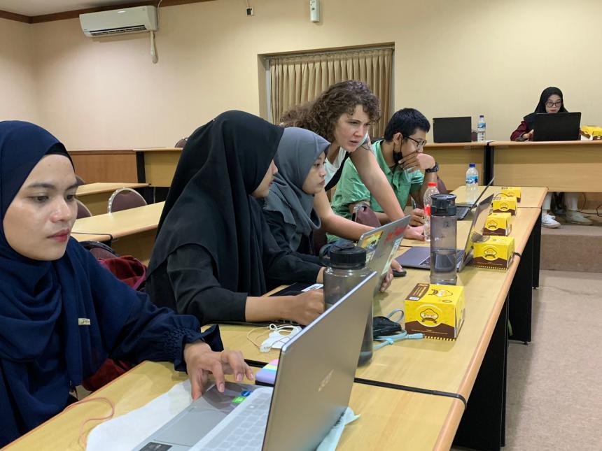 6 people working on laptops at their desks