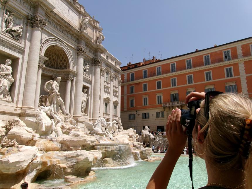 Here, a student photographs the details of the Trevi Fountain in Rome, Italy, taking special notice of cultural impacts the high tourism rate has on the centuries-old marvel.