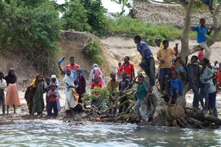 People in Zanzibar buzy on a riverbank.
