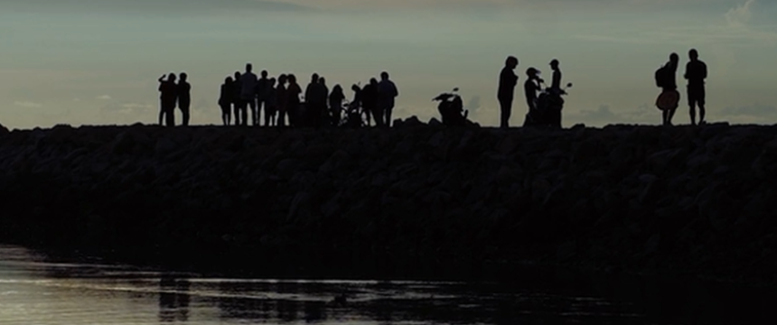 people on small jut of land